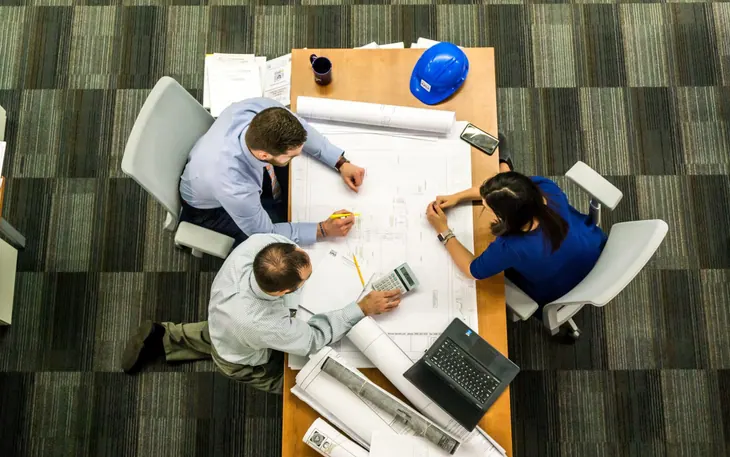 Team working around a table seen from above
