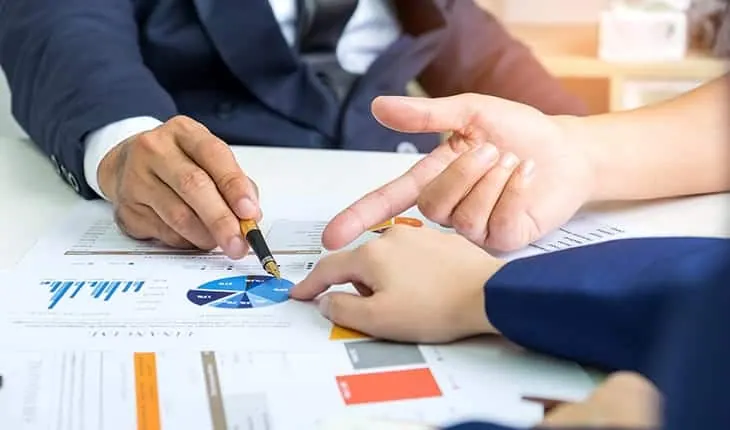 Consultants reviewing charts together